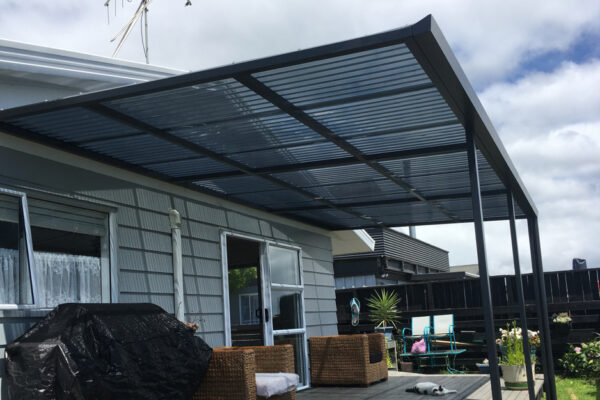 A mono-pitch pergola covering a small back patio.