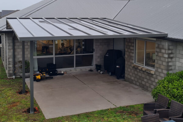 A newly installed pergola covers a small patio area.