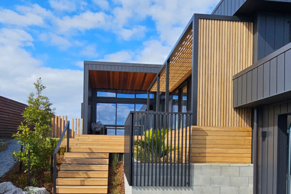 Steps leading up to a pergola covering an entryway.