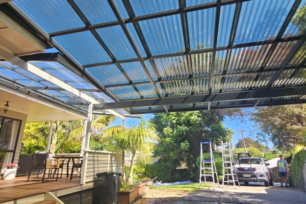 Extended pergola off of a deck creating space for a carport.