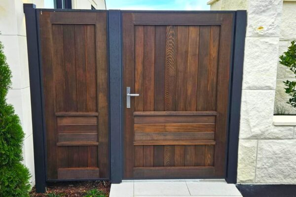 Pedestrian gate with aluminium frame and solid wood insert.