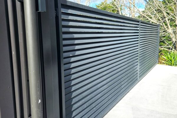 A louvre-style swing gate protects a driveway entrance.